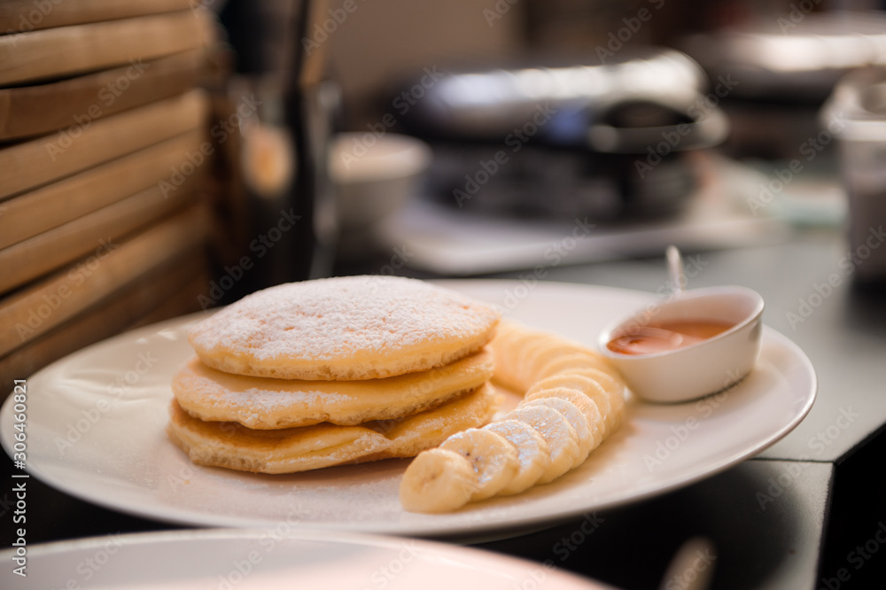 pancakes with banana on white dish pancakes with banana on white dish