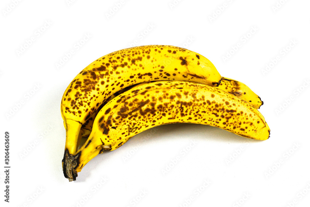 Organic bananas with freckles on fruit peels Organic bananas with freckles on fruit peels