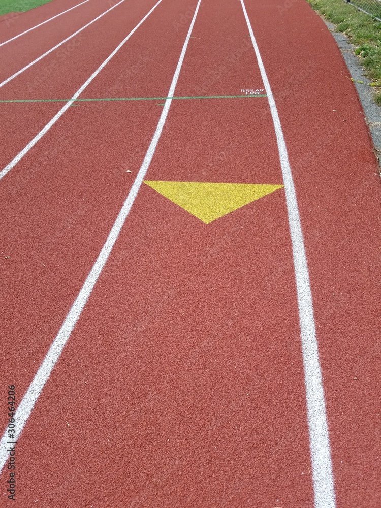 running track with yellow arrows