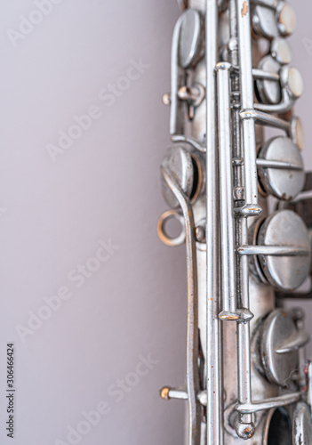 Canvas Print Silver saxophone isolated on light grey background.