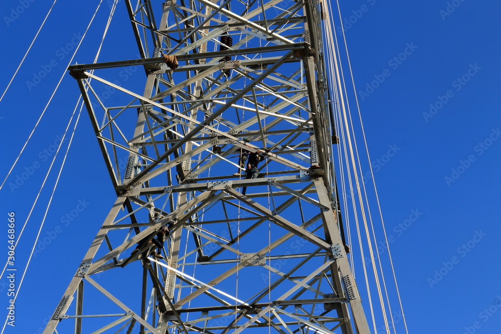 electricity pylon against blue sky