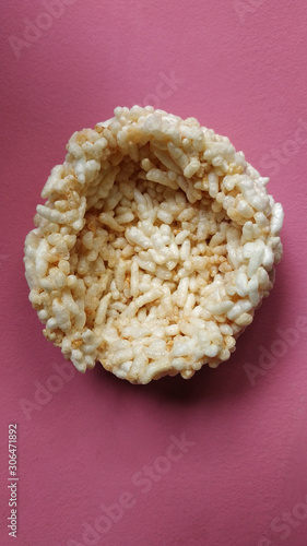 Rengginang. Traditional Indonesian Snack Made from Rice and Fried. Crunchy and Crispy Snack. Isolated on Pink Background