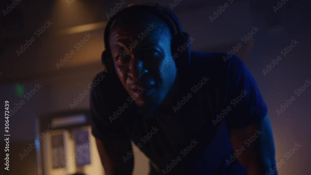 African-American athlete taking a break, intense working out, listening to music while training, dramatic lightning, shot on Red Weapon Helium African-American athlete taking a break, intense working out, listening to music while training, dramatic lightning, shot on Red Weapon Helium