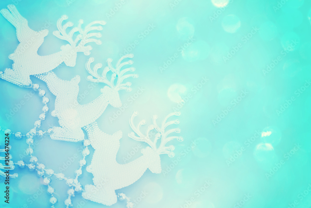 Obraz premium Reindeer glitter on bright blue Christmas card. Beautiful Christmas background with reindeer and place for text.