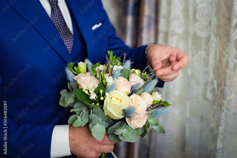 the bride holds a wedding bouquet with roses the bride holds a wedding bouquet with roses