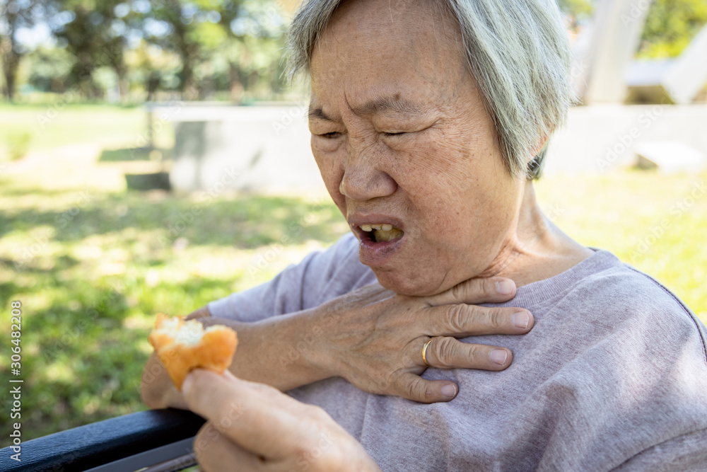 Asian senior woman suffers from choke and cough,clogged up food,elderly
