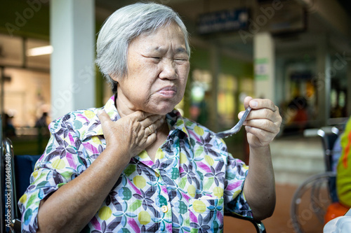 Bild auf Leinwand Asian senior woman suffers from choke,clogged up food,elderly people choking dur