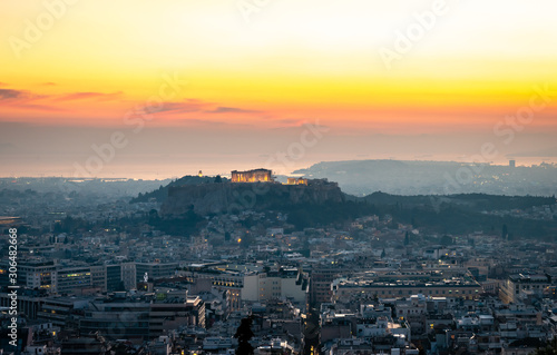 The Athens skyline, in Greece, in twilight. The Acropolis dominates the picture, while Filopappos Hill and the city of Piraeus are the background. photo