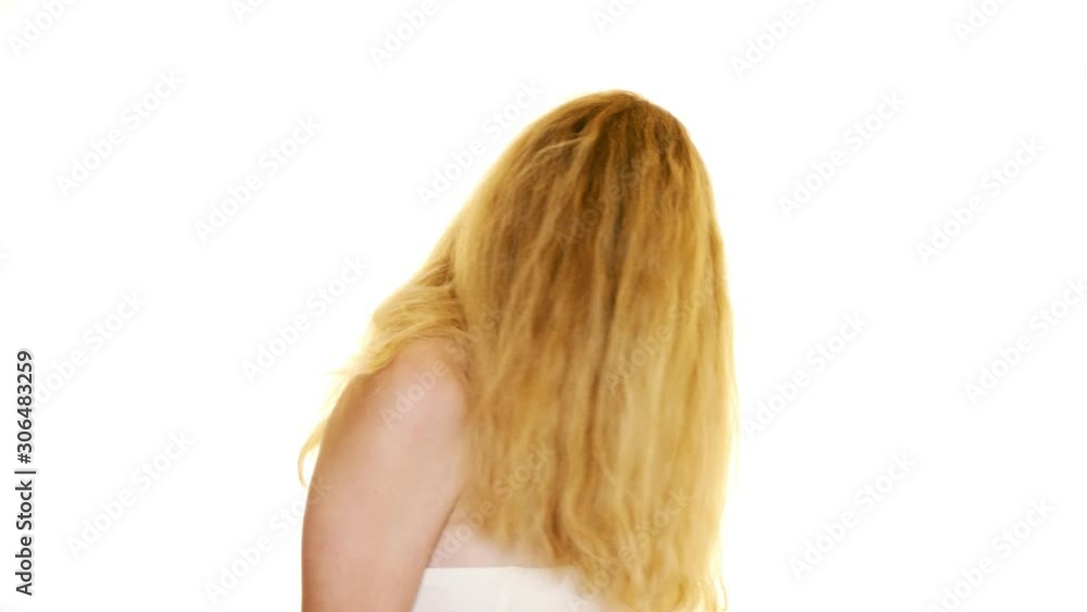Beautiful red haired young girl turning and flicking her hair about on a seamless white studio background in slow motion Beautiful red haired young girl turning and flicking her hair about on a seamless white studio background in slow motion