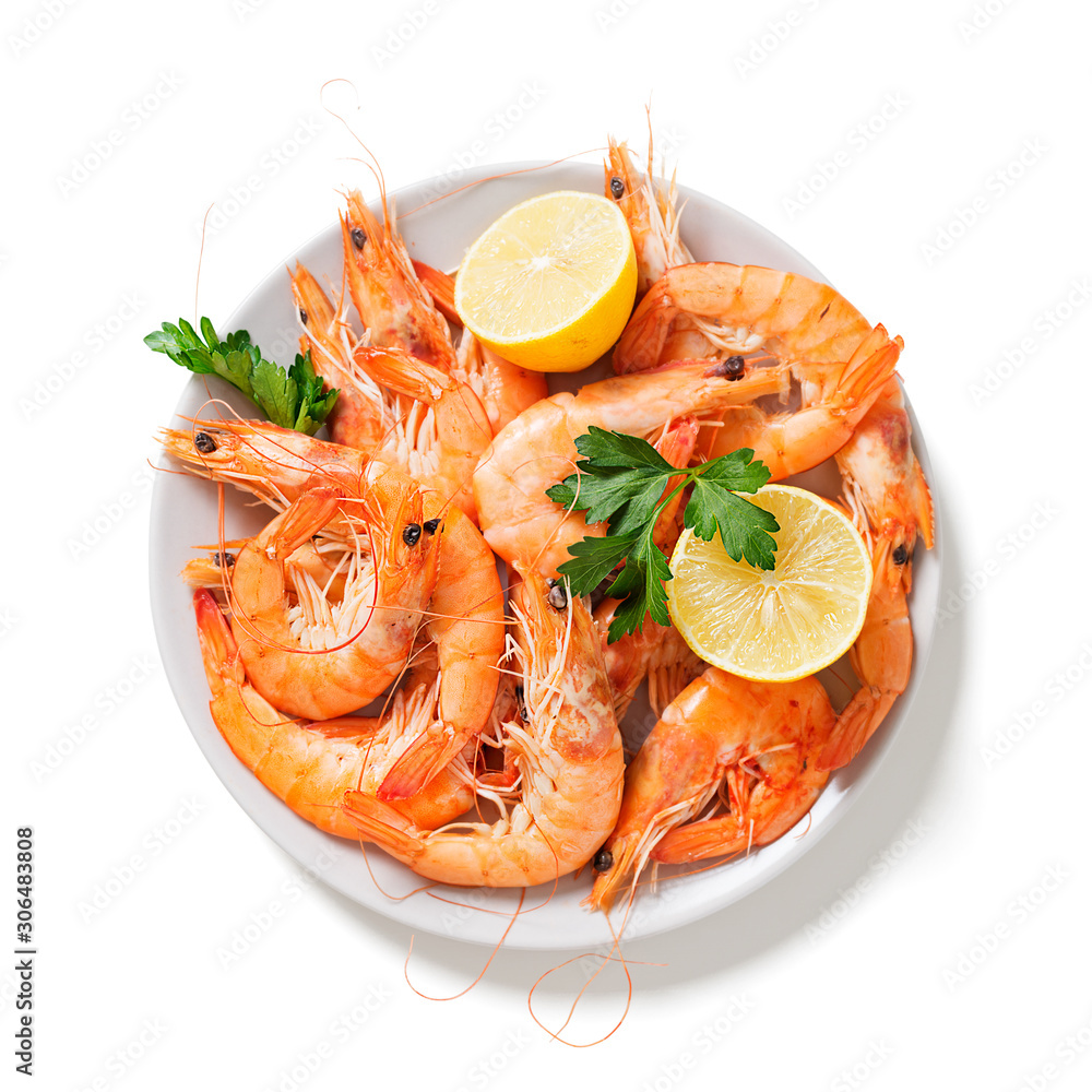 Steamed shrimps with lemon and herbs. Seafood, shellfish. Shrimps prawns on plate. isolated on white background Steamed shrimps with lemon and herbs. Seafood, shellfish. Shrimps prawns on plate. isolated on white background