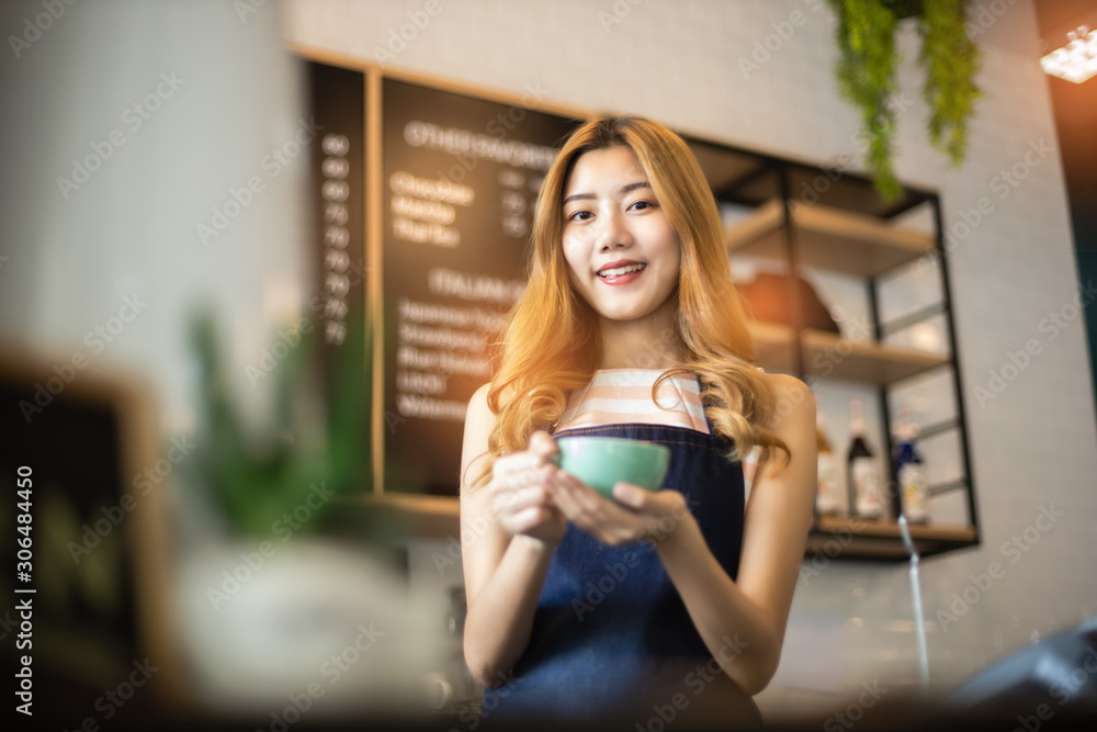 Portrait young Asian woman barista feeling happy smiling at urban cafe. Small business owner Korean girl in apron relax toothy smile