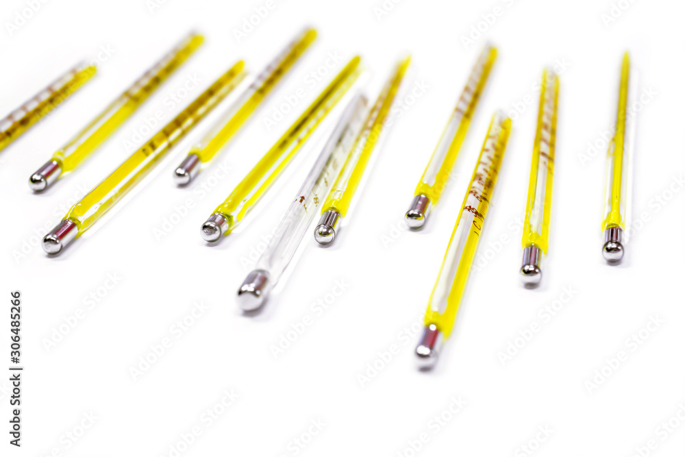 Closeup small medical thermometers line up isolate on white background. Closeup small medical thermometers line up isolate on white background.