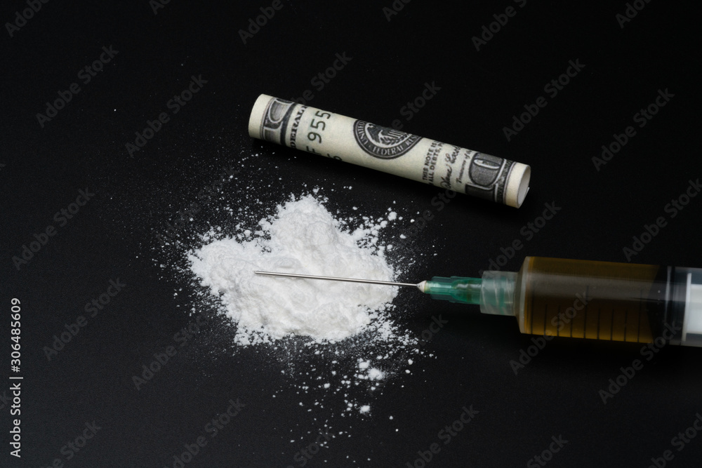 Obraz premium Cocaine or other illegal drugs, white powder, syringe, isolated on black glossy background