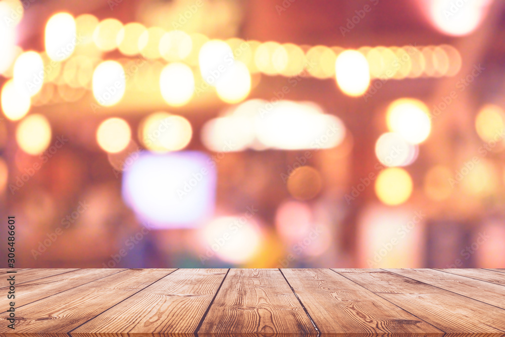 Wood table top with blurred light bokeh in restaurant background Wood table top with blurred light bokeh in restaurant background