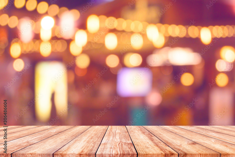 Wood table top with blurred light bokeh in restaurant background