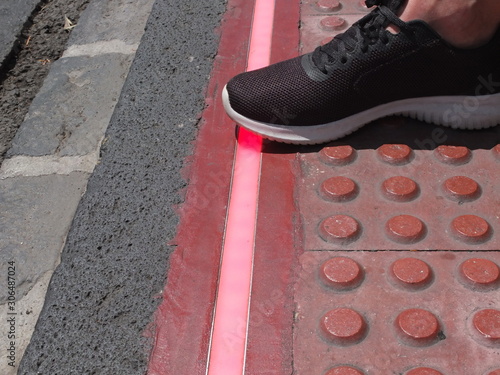 LED strip on the pedestrian road. Braille Blocks in the pedestrian guiding the blinds walks. Traffic sign for pedestrians. 