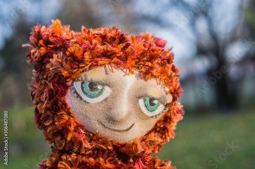 Fototapeta Naklejka Na Ścianę i Meble -  Handmade plush knitted toy with acrylic painted face.