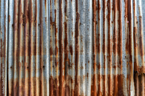 Rusted galvanized iron plate, red stain on old metal sheet wall texture.