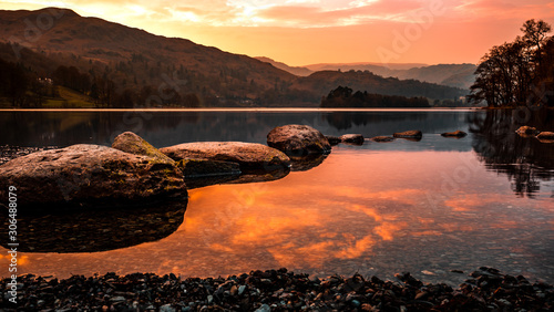 Grasmere lake in Cumbria, United Kingdom. Lake reflections in the fall season. Autumn colors on a calm evening. photo