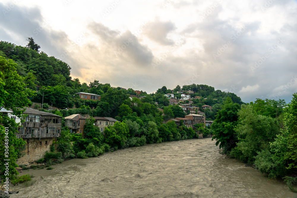 Old wrecked buildings of Kutaisi and the mountain river right in the city centre