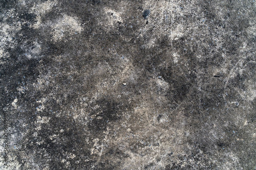 Grunge gray concrete floor as a texture background wallpaper. Ground cement abstract. Old dirty floor with black stains from mold on concrete surface.