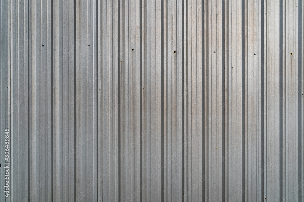 Pattern of old metal sheet roof texture. Rusty metal sheet texture. Aluminium Metal sheet roof for background or wallpaper. Silver white Corrugated metal texture surface. Pattern of old metal sheet roof texture. Rusty metal sheet texture. Aluminium Metal sheet roof for background or wallpaper. Silver white Corrugated metal texture surface.