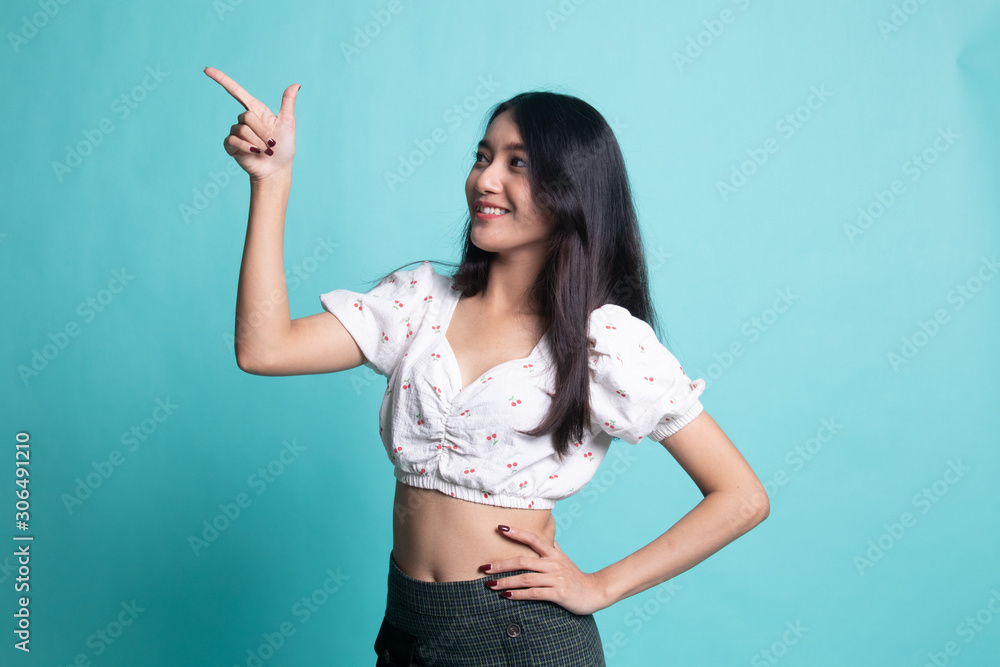 Young Asian woman smile and point. Young Asian woman smile and point.