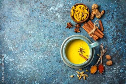 Healthy drink of golden turmeric milk with spices photo