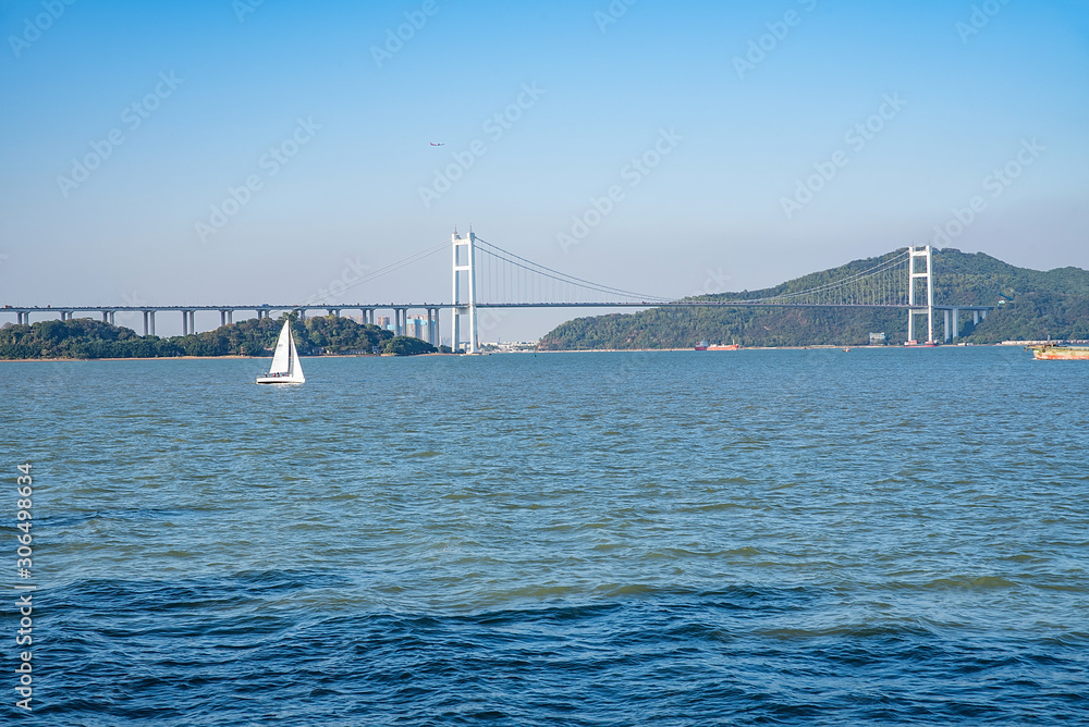 Prospect of sailing boat and Humen Bridge above the Pearl River Estuary, Guangdong, China Prospect of sailing boat and Humen Bridge above the Pearl River Estuary, Guangdong, China