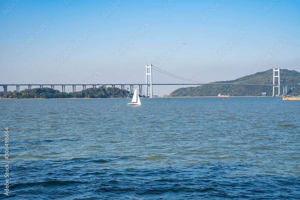 Prospect of sailing boat and Humen Bridge above the Pearl River Estuary, Guangdong, China Prospect of sailing boat and Humen Bridge above the Pearl River Estuary, Guangdong, China