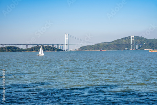 Prospect of sailing boat and Humen Bridge above the Pearl River Estuary, Guangdong, China