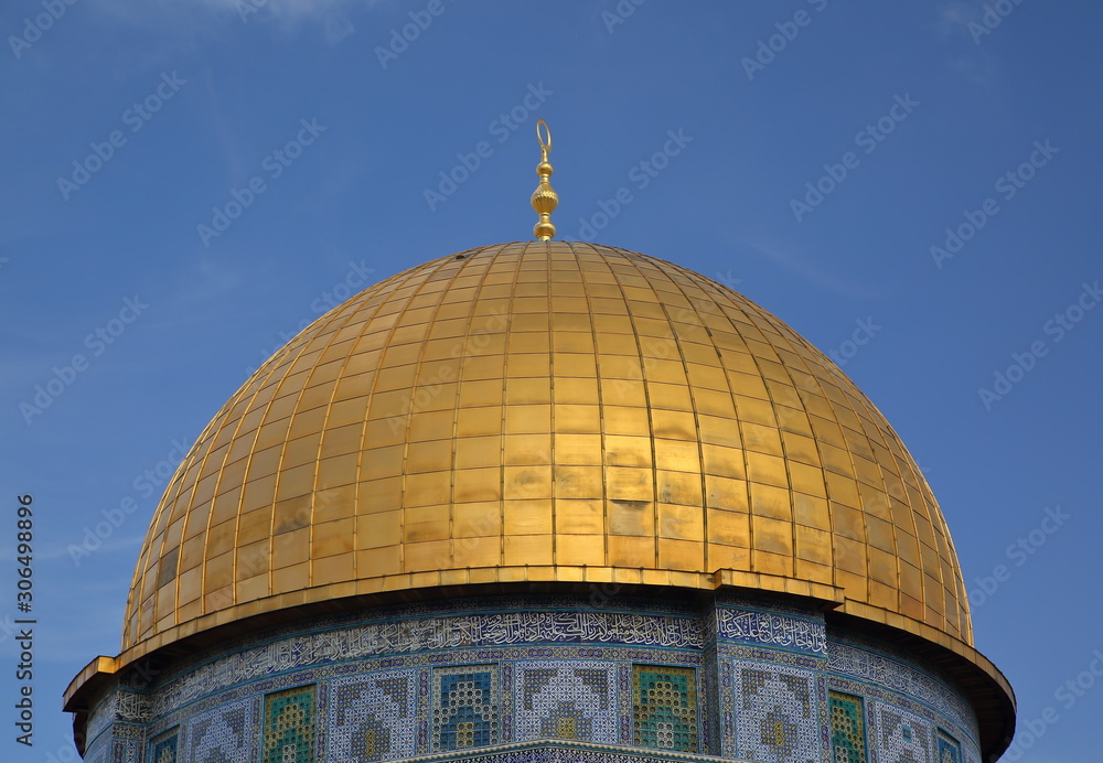Golden cupola of dome of rock in jerusalem, close up, against blue sky