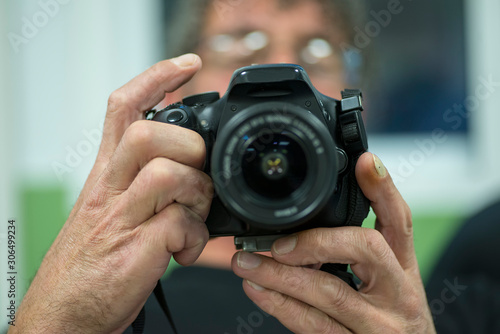 man using reflex photo camera