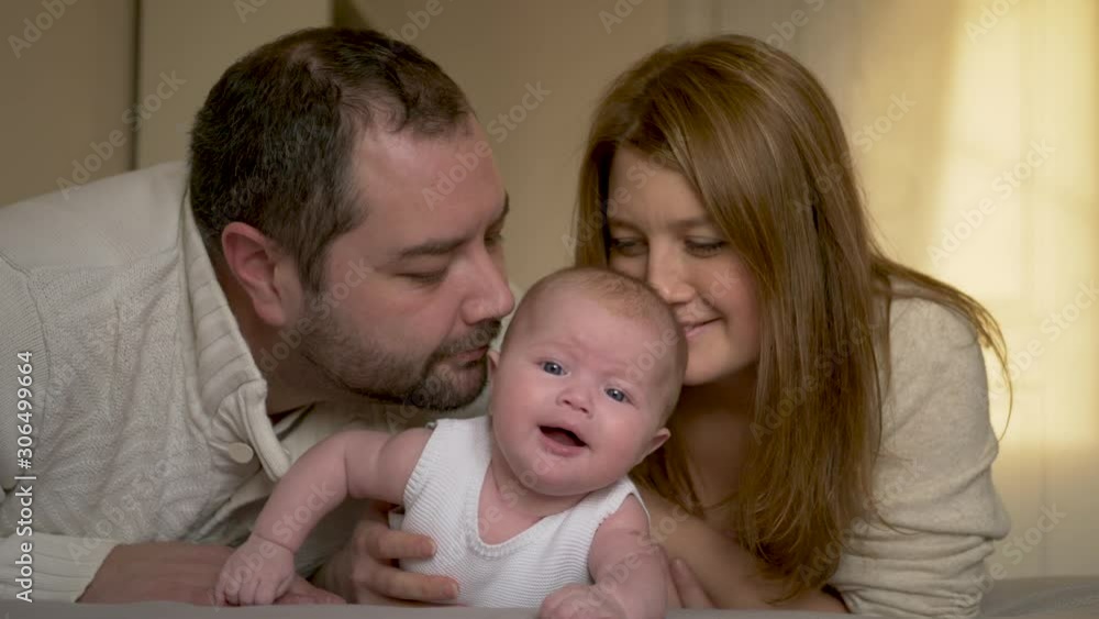 family mom dad and daughter lying on the bed family mom dad and daughter lying on the bed