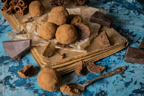 Craft chocolate truffles on turquoise background