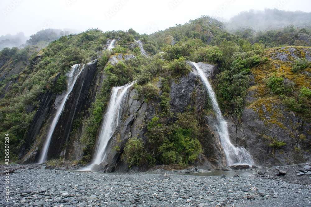 Beautiful waterfall in Franz Joseph Glacier trail, New Zealand.