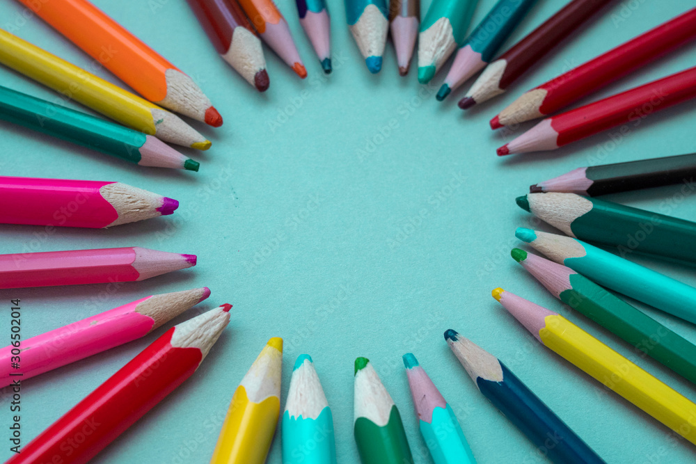 many multi-colored pencils on isolated on a blue background many multi-colored pencils on isolated on a blue background