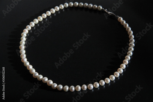 A pearl necklace for woman isolated on black background