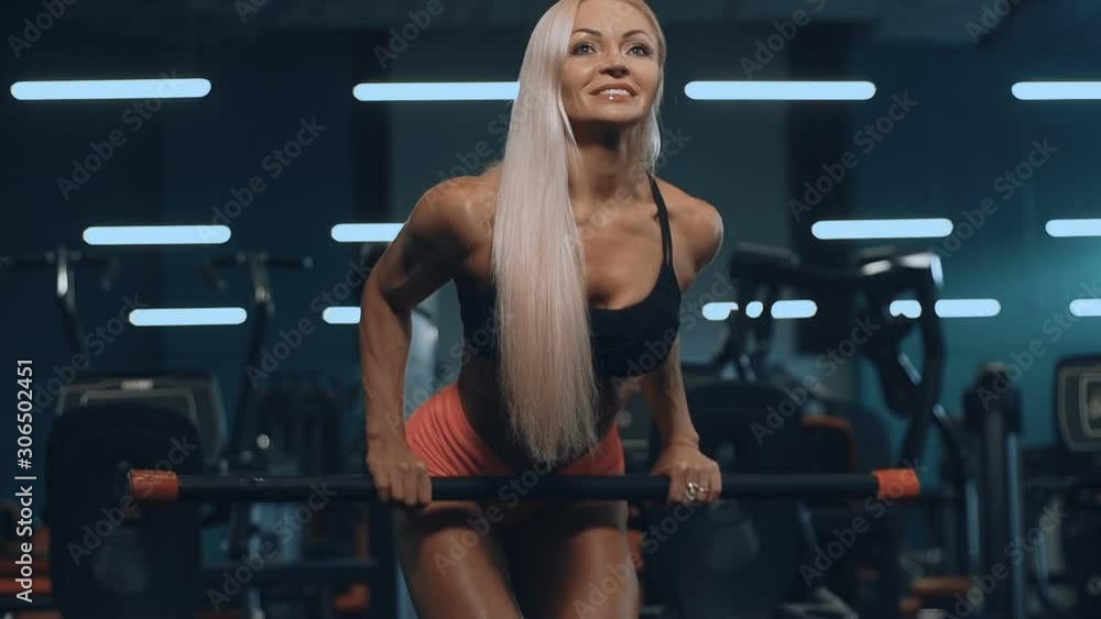fitness beautiful caucasian woman gym work out back Bent-over rows exercises in gym pumping up muscles workout fitness and bodybuilding concept naked torso fitness beautiful caucasian woman gym work out back Bent-over rows exercises in gym pumping up muscles workout fitness and bodybuilding concept naked torso