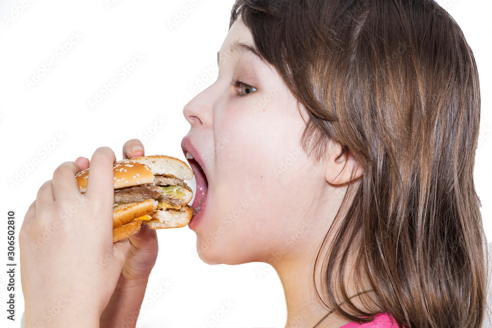 portrait of a beautiful girl, teenager and schoolgirl, holding a hamburger on a white background. portrait of a beautiful girl, teenager and schoolgirl, holding a hamburger on a white background.