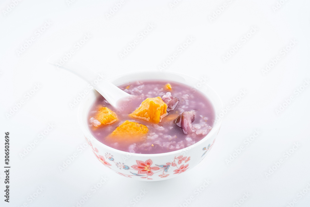 Purple sweet potato porridge in a bowl on white background Purple sweet potato porridge in a bowl on white background