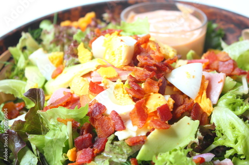 Healthy Salad with Dressing in Wood Bowl