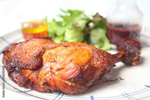 Roasted chicken leg with sauce and salad