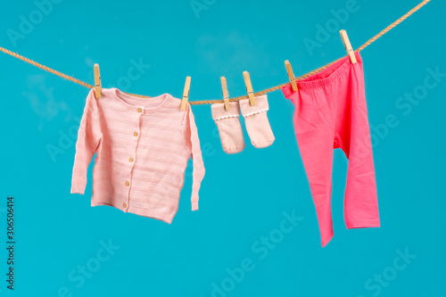Clothesline with pinned baby clothes close up
