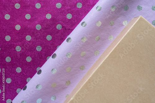 Lilac and violet shiny polka dot wrapping paper, boxes. Foil for gift wrapping design. photo