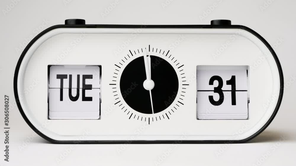 Five minutes to twelve, flip clock time lapse, changing dates and days of the week on the modern calendar from Tuesday 31 to Wednesday 1 on a white background Five minutes to twelve, flip clock time lapse, changing dates and days of the week on the modern calendar from Tuesday 31 to Wednesday 1 on a white background