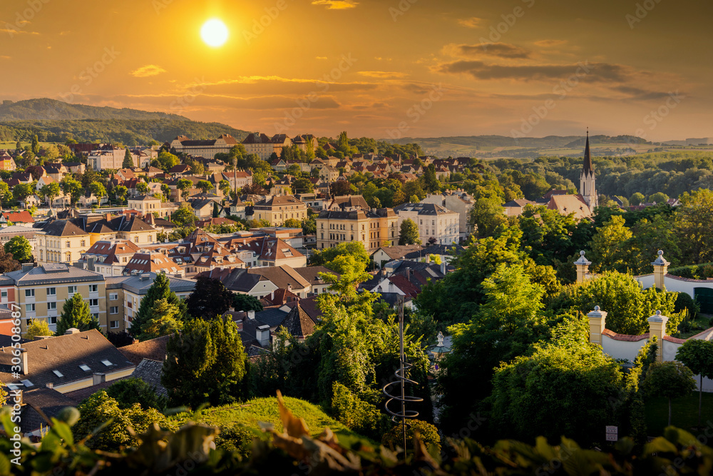 View of the buildings and roofs of the picturesque town of Melk on a sunset, Lower Austria, Wachau Valley.