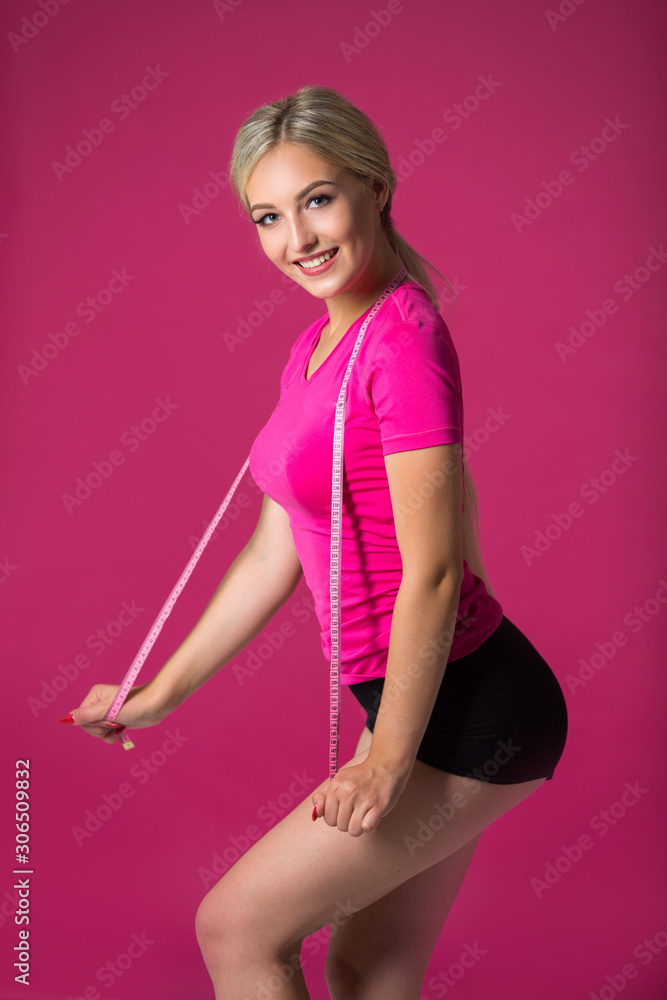 beautiful young woman in sportswear on a pink background beautiful young woman in sportswear on a pink background