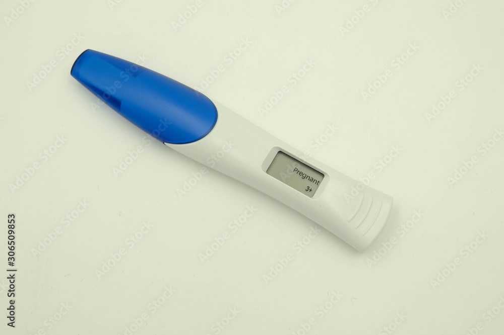 Digital pregnancy test with weeks estimator over white background Digital pregnancy test with weeks estimator over white background