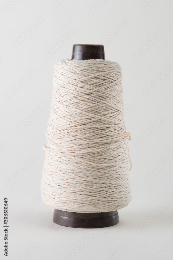Fotografie spool of thick white thread on a white background.
